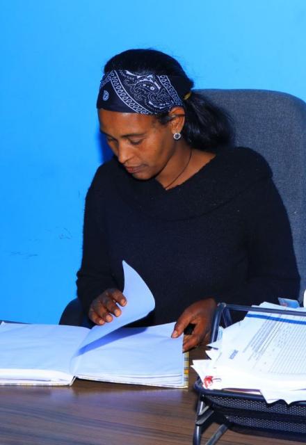 A picture of Abebu sitting at a desk