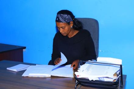 A picture of Abebu sitting at a desk